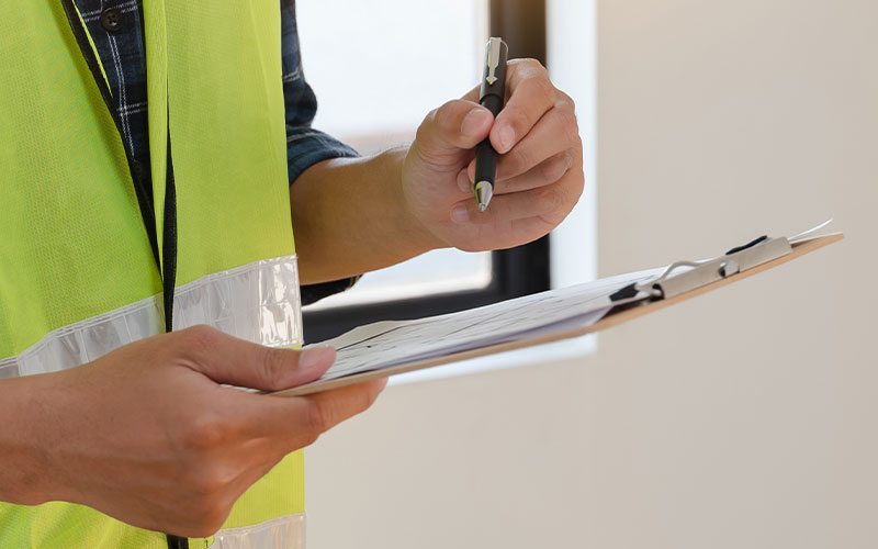 Surveyor working on completeing a building condition report